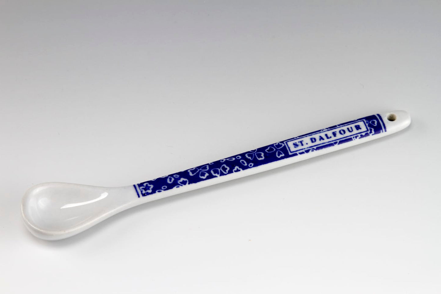 White and blue St. Dalfour ceramic spoon.