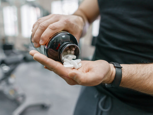closeup of a man taking the best natural testosterone booster in the gym
